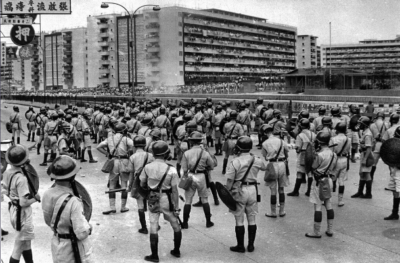 圖四：1967年5月12日，騷亂擴展至東頭邨，隔著大水渠對峙。陳橋離開警隊範圍拍攝遇險。（陳橋攝，《南華早報》授權使用。